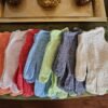 Exfoliating Gloves showing 7 pairs of different colors